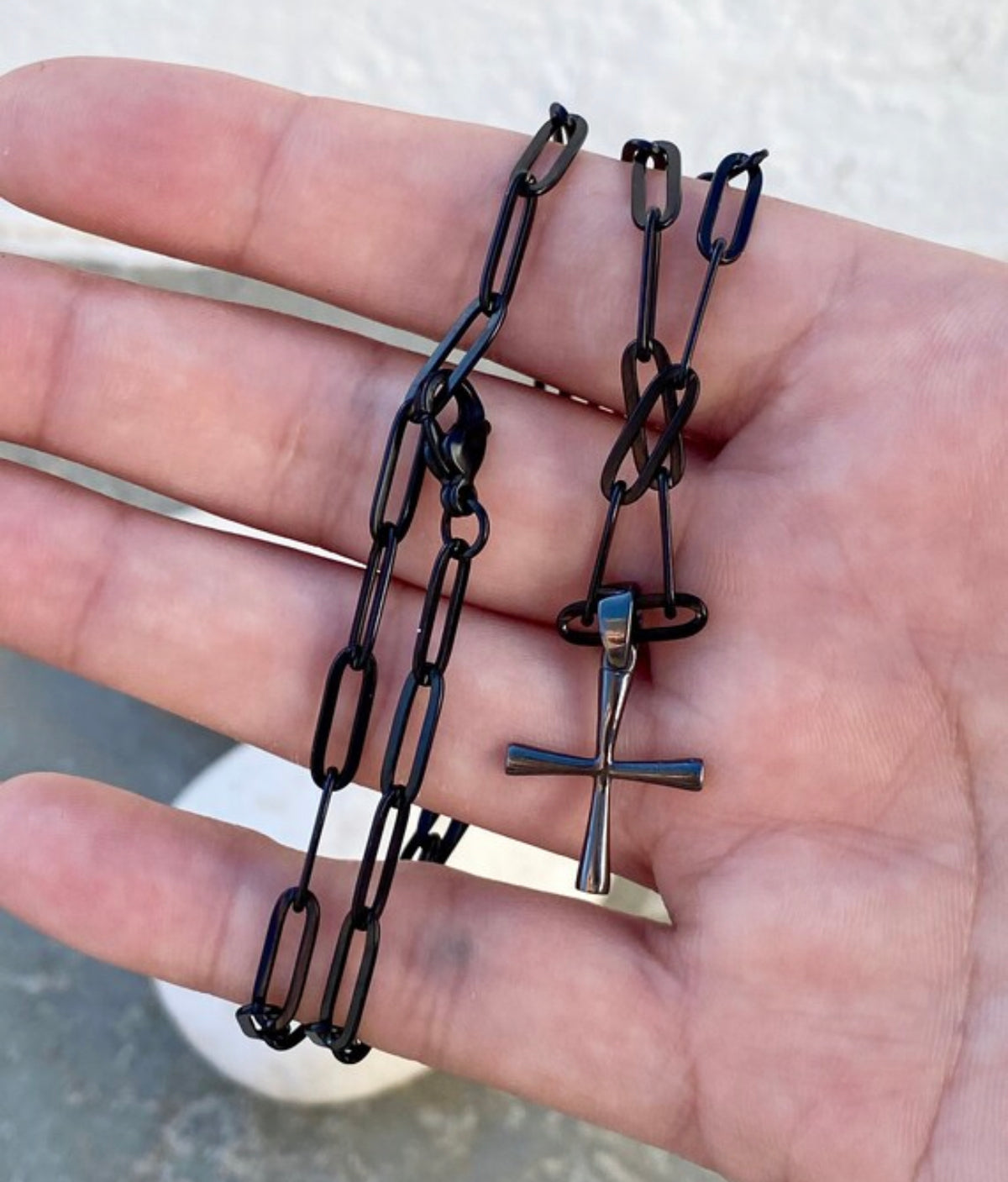 black cross with black paper clip chain