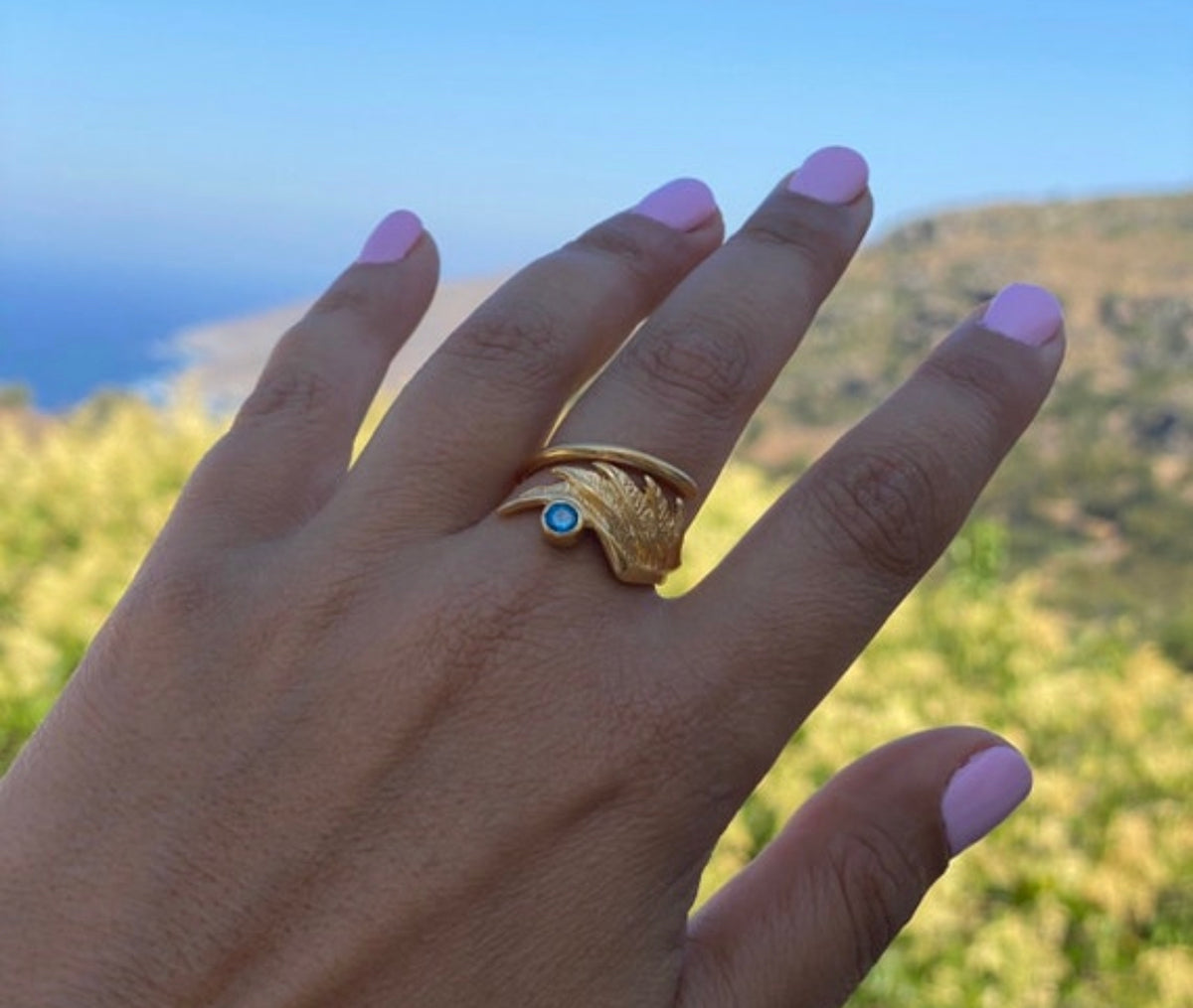 angel wing ring with blue gemstone