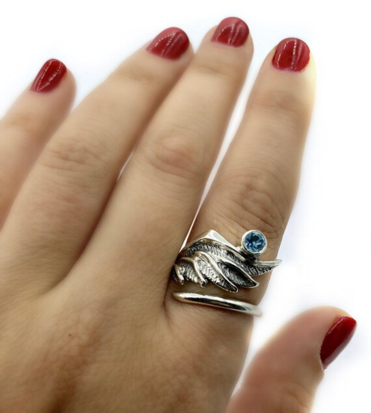 silver angel wing with a blue topaz