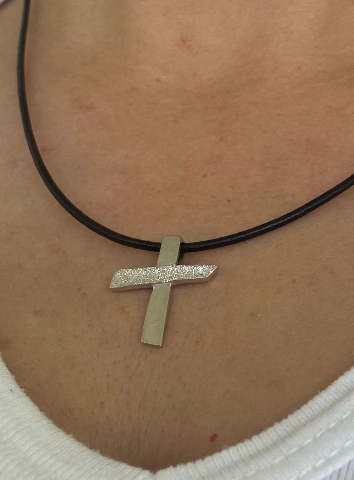 silver cross with black leather