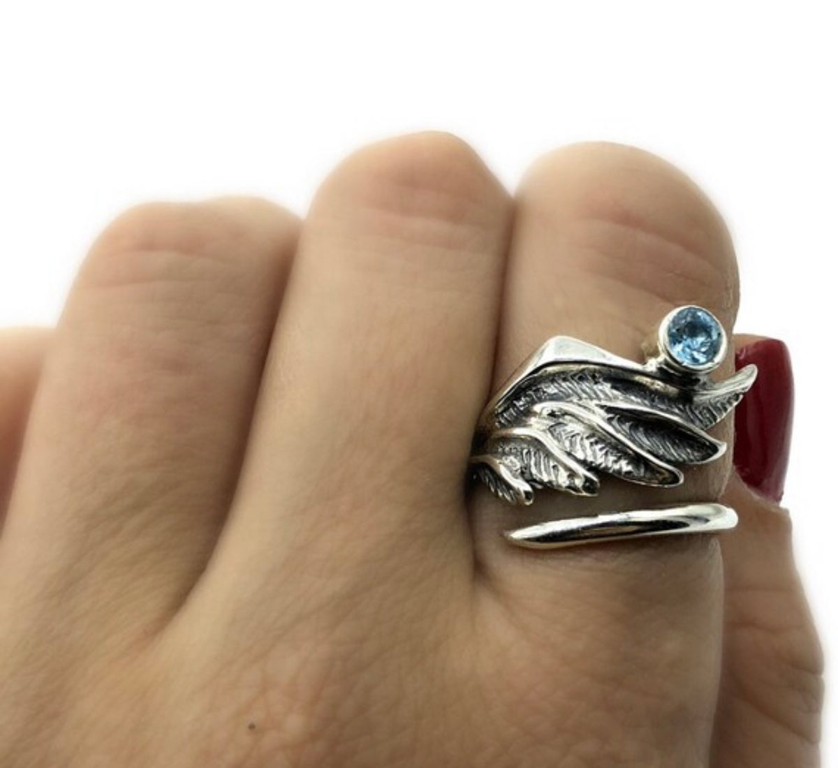 silver angel wing with a blue topaz