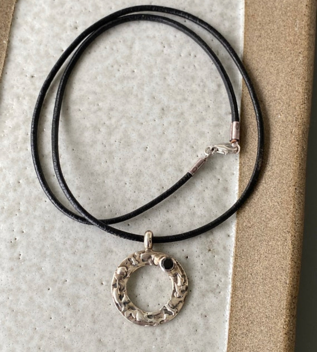 handmade circle necklace with a black gemstone