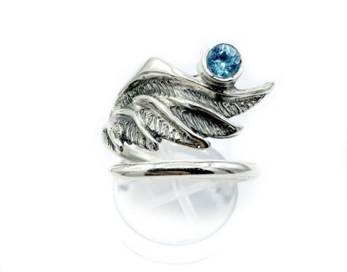 silver angel wing with a blue topaz