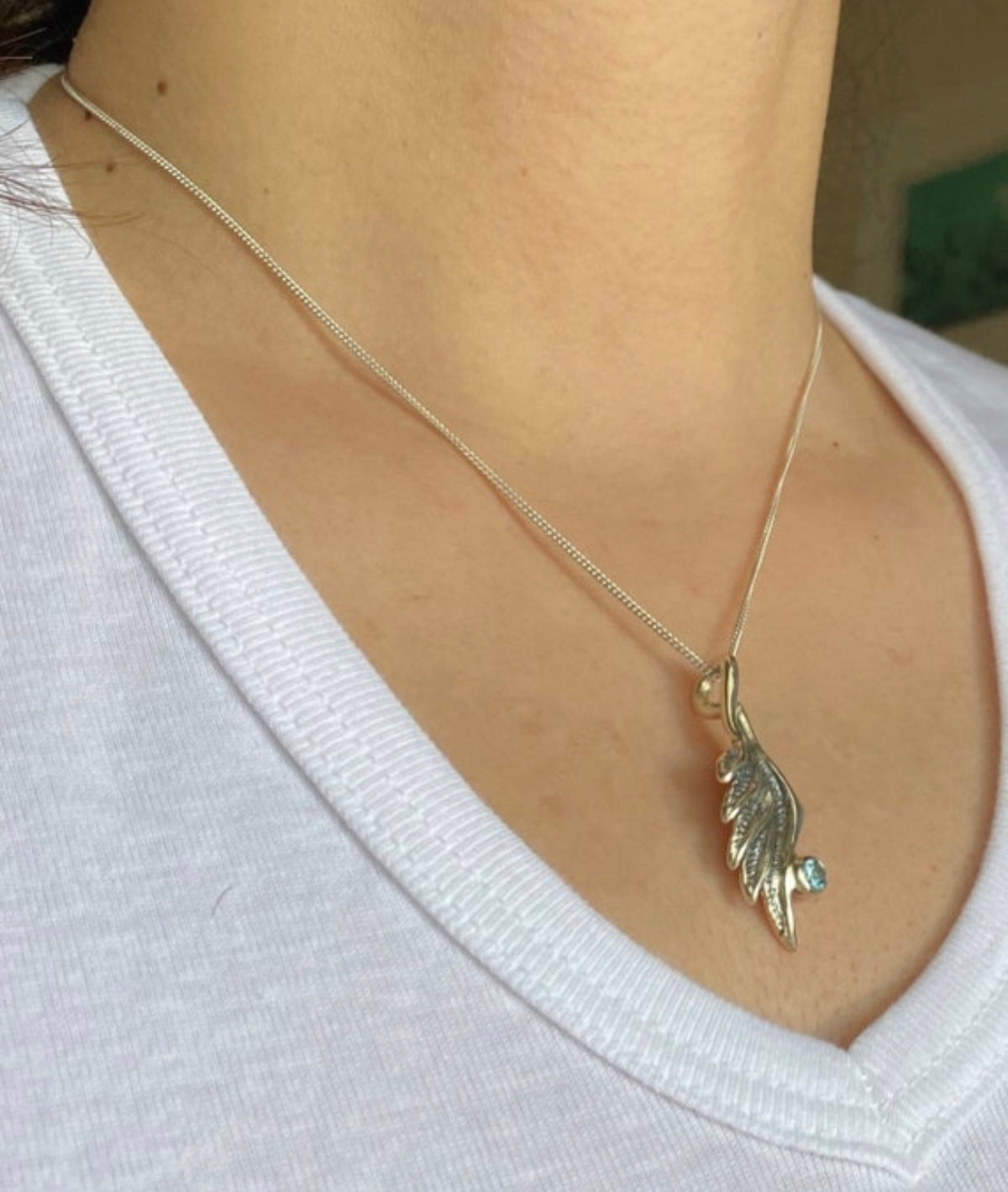 angel wing necklace with blue topaz